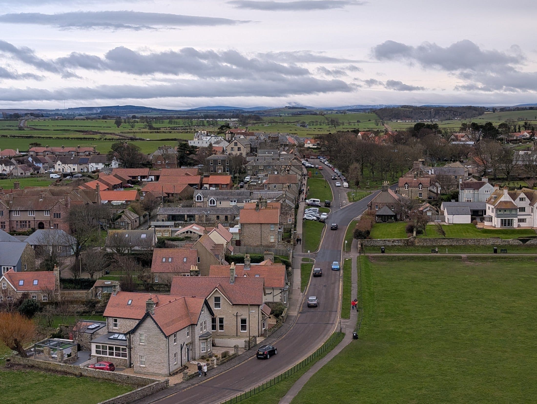 Bamburgh village from the castle walls, with the Cheviot Hills beyond